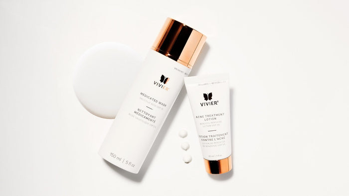 Vivier Medicated Wash and Acne Treatment Lotion displayed on a white background with cleanser texture and product droplets.